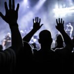 group of people raising hands silhouette photography